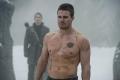 Oliver Queen from Arrow is shirtless showing many scars on his torso.