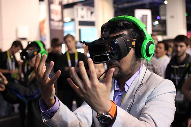 Man wearing VR headset looking at his hands.