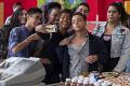 Still from On My Block with the whole gang taking a selfie at a cash register.